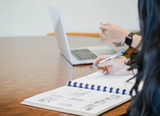 photo of student taking notes