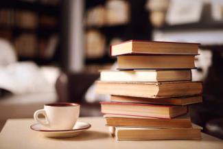 image of a stack of untitled books and a tea cup