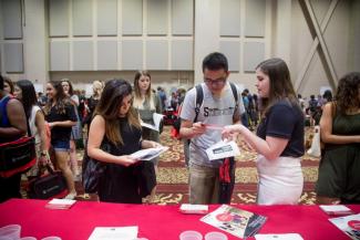 photo of new students at a previous graduate school information fair