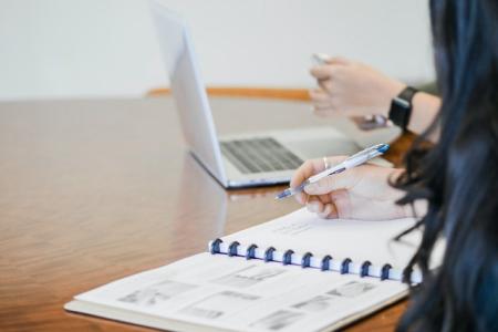 image of student with agenda and laptop