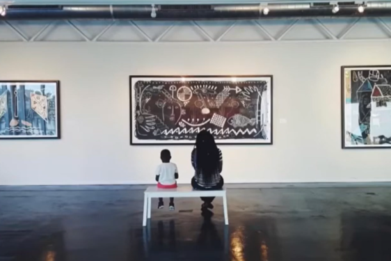 photo of viewers of art at Houston Museum of African American Culture